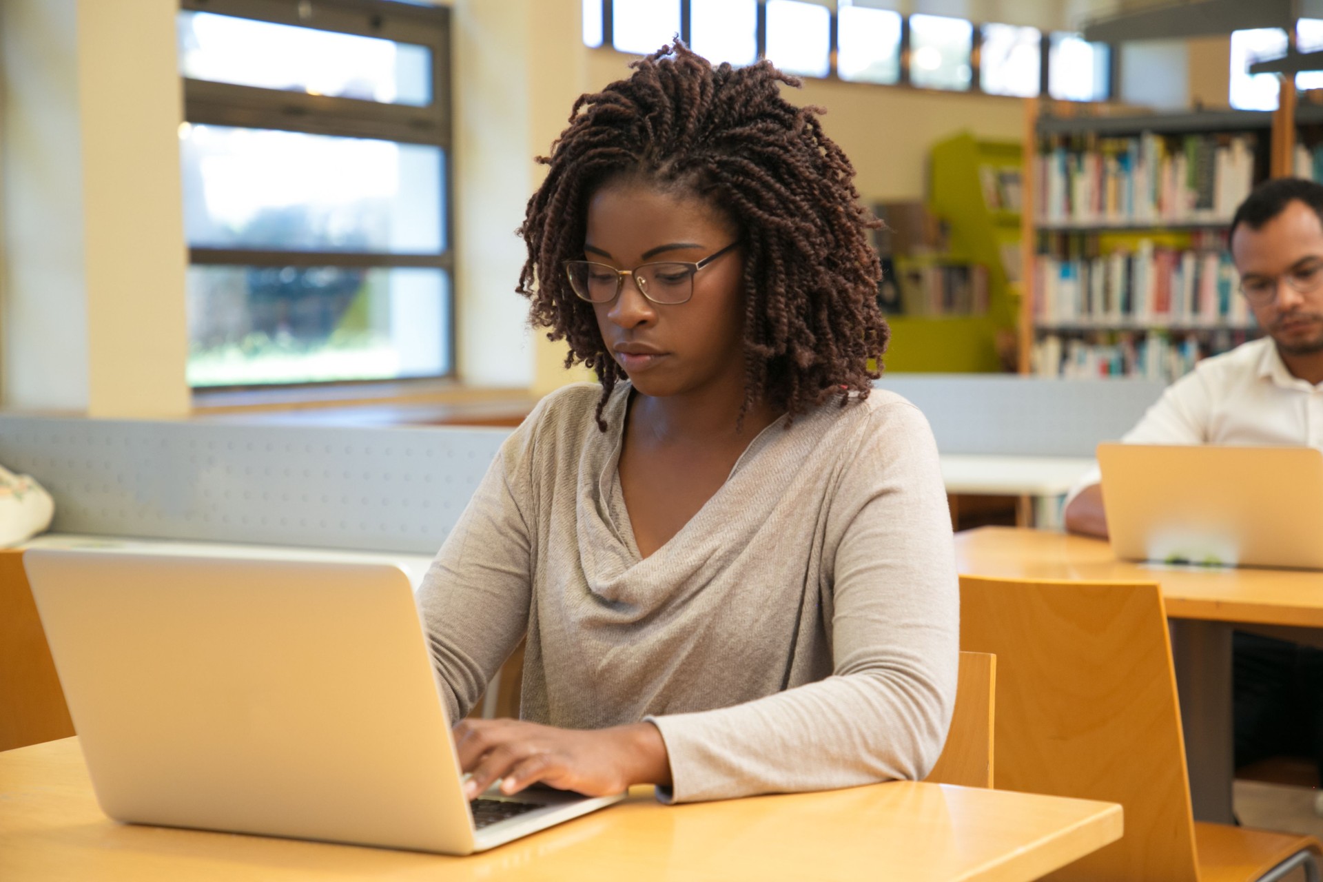 Focused student working in library computer class